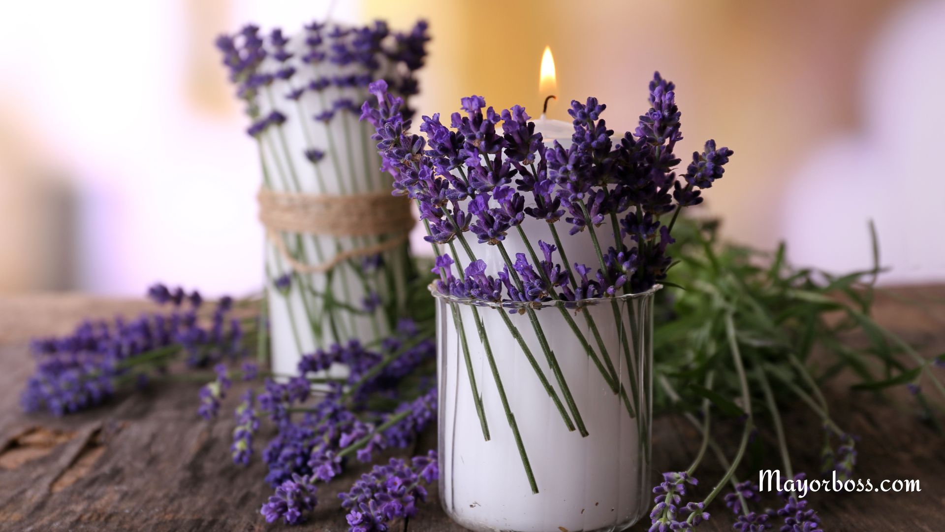 candles with lavender flowers on a wooden table