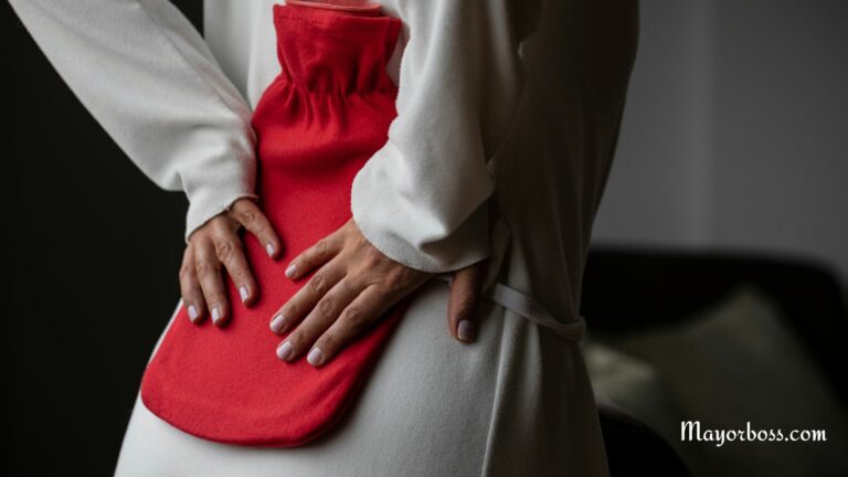 Woman With Back Ache Using Hot Water Bottle