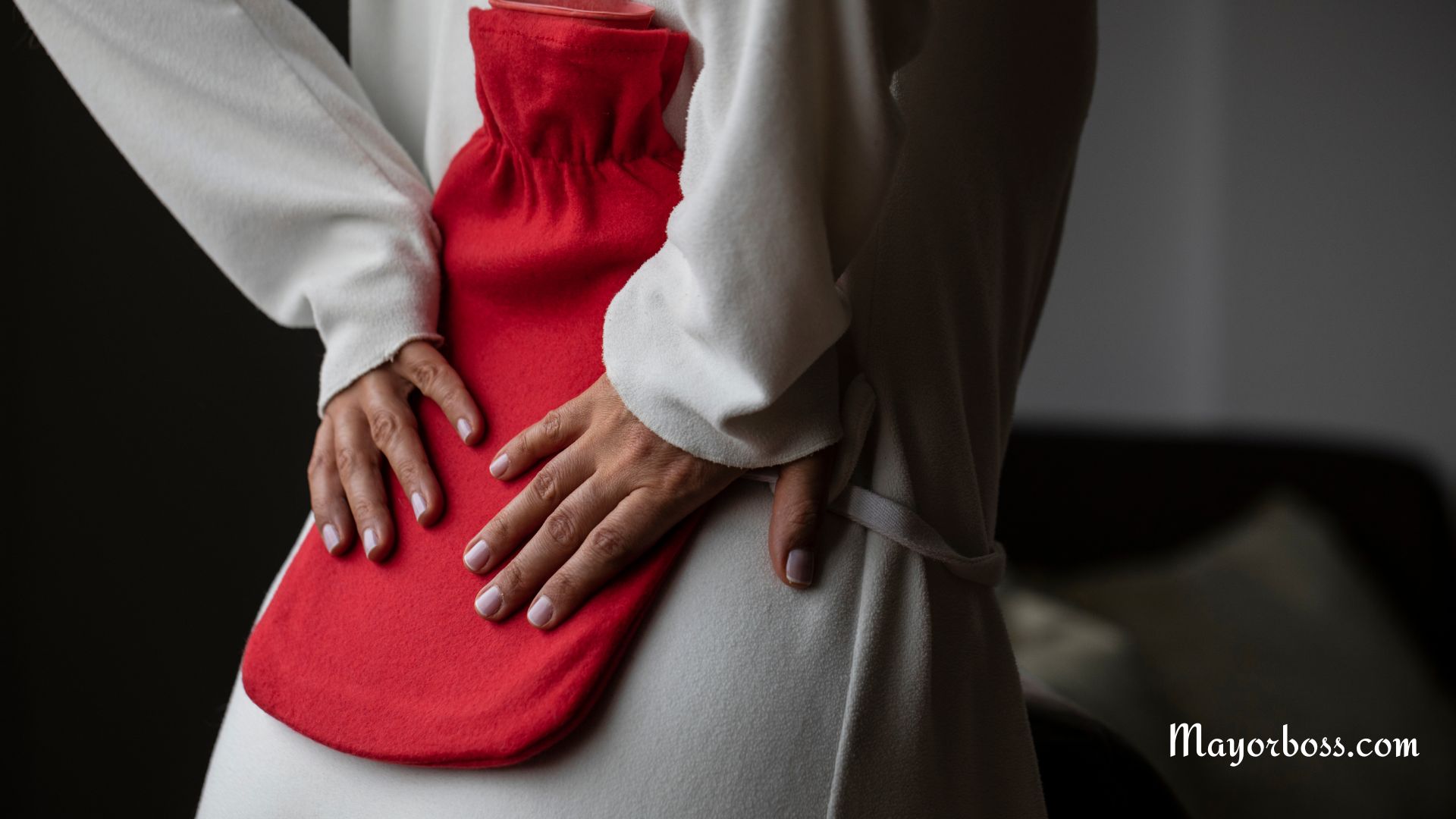 Woman With Back Ache Using Hot Water Bottle